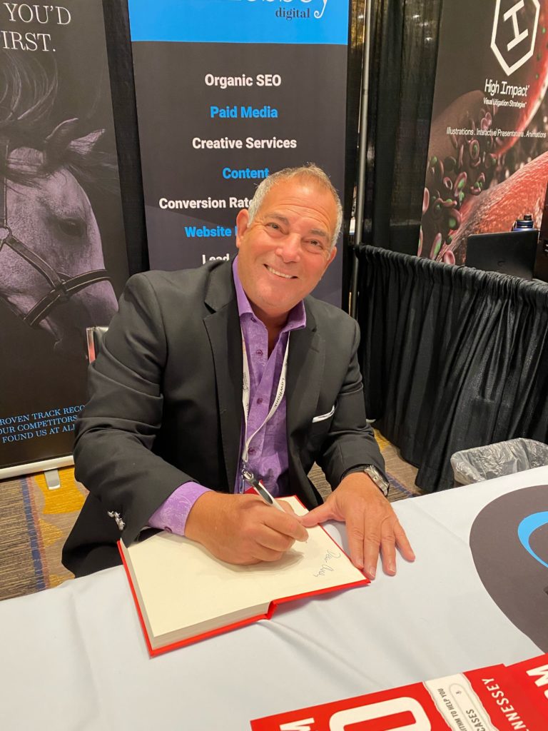 Paul Lieberman of X Social Media signs copies of Law Firm SEO