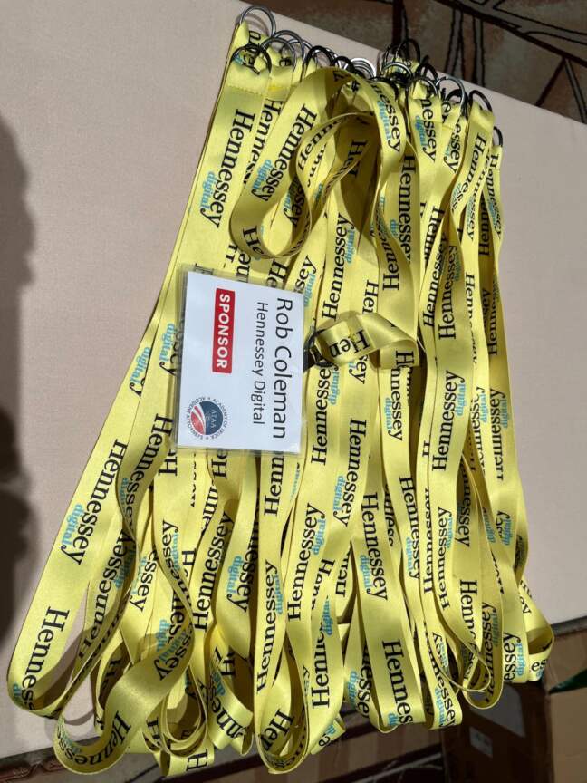 Yellow Hennessey Digital lanyards and a name badge for Rob Coleman at the Academy of Truck Accident Attorneys event