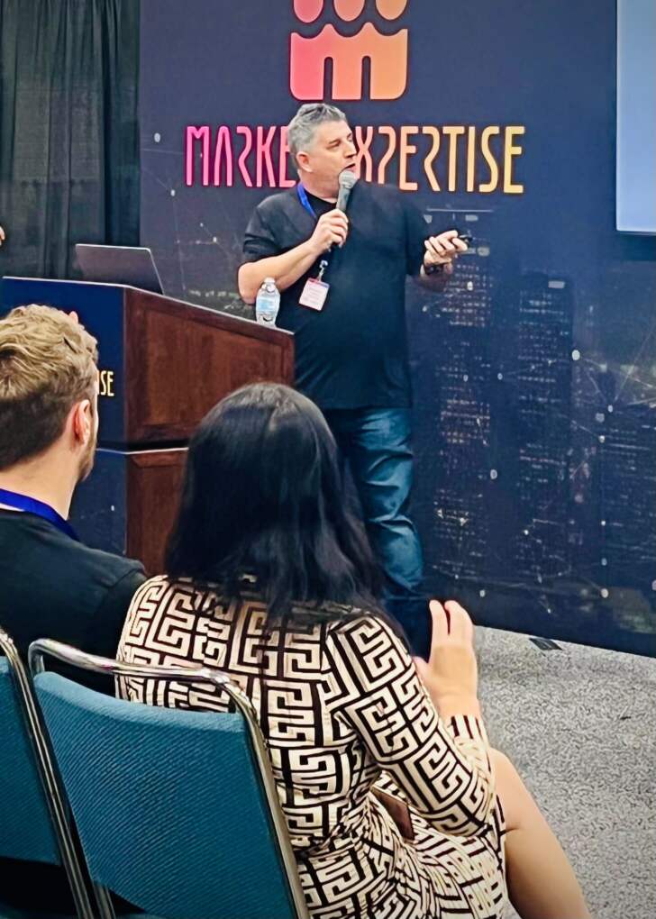 Speaker presenting at a podium on the Marketing Expertise stage at the B2B Marketing Expo