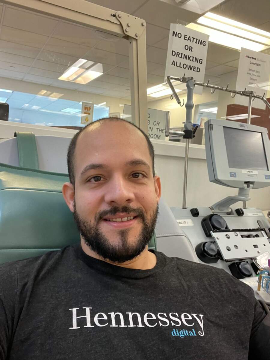 Charlie in a Hennessey Digital T-shirt at a donation center during RAK Week