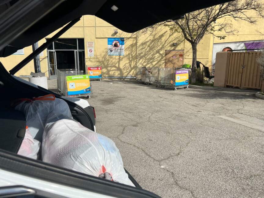 Bags of clothing in a car trunk ready for donation