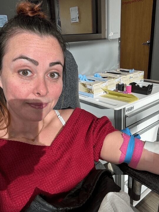 Team member taking a selfie with a bandaged arm after donating blood during RAK Week